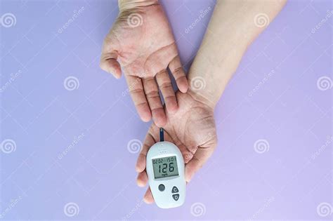 Hand Of People Check Diabetes And High Blood Glucose Monitor With