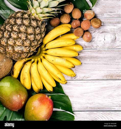 fresh tropical fruit  wood top view bananas pineapple coconut