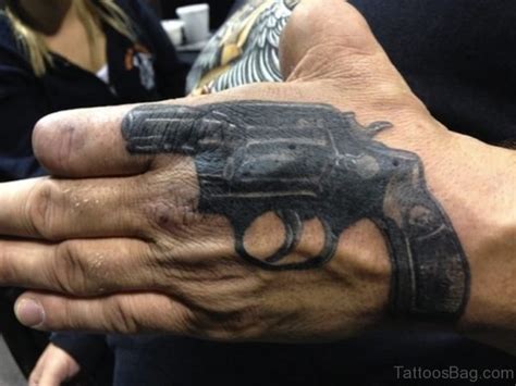 28 Funky Gun Tattoos On Hand Tattoo Designs