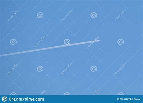 Distant Passenger Jet Plane Flying On High Altitude On Clear Blue Sky