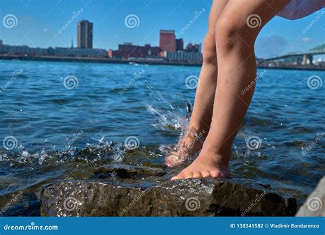 Children`s Feet in the Water. Spray Feet from the Water Stock Photo ...