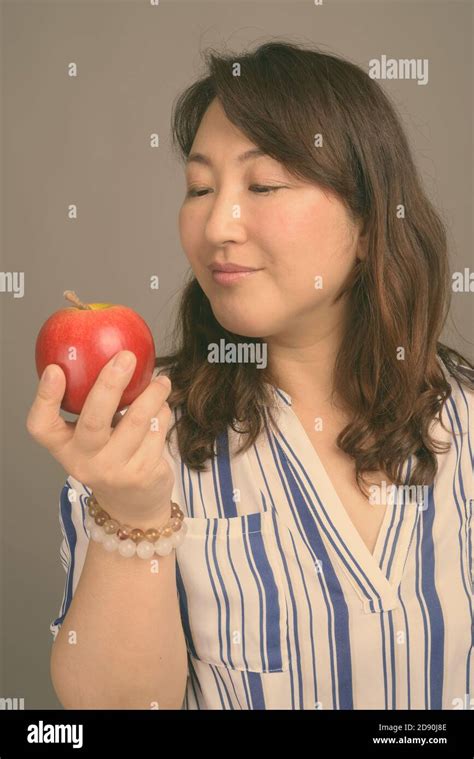 Mature Beautiful Asian Businesswoman Against Gray Background Stock Photo Alamy