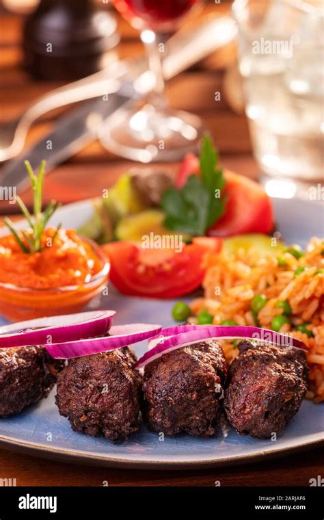 closeup of cevapcici with djuvec rice Stock Photo - Alamy