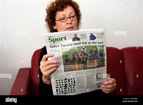 Woman Reading A Copy Of The Times Newspaper Hi Res Stock Photography