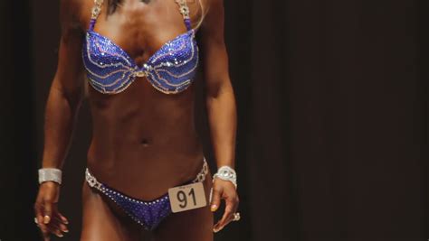 Beautiful Female Fitness Bikini Model Demonstrating Sexy Fit Body At Contest Stockvideos