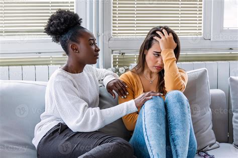 Woman hugging her depressed friend at home, closeup. Young girl ...