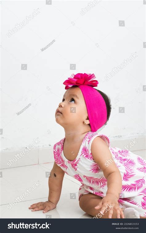 Baby Latina Sitting On Floor Looking Stock Photo Shutterstock
