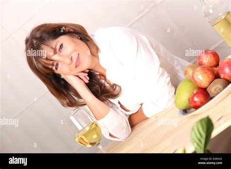 A Beautiful Mature Woman With A Glass Of White Wine Stock Photo Alamy