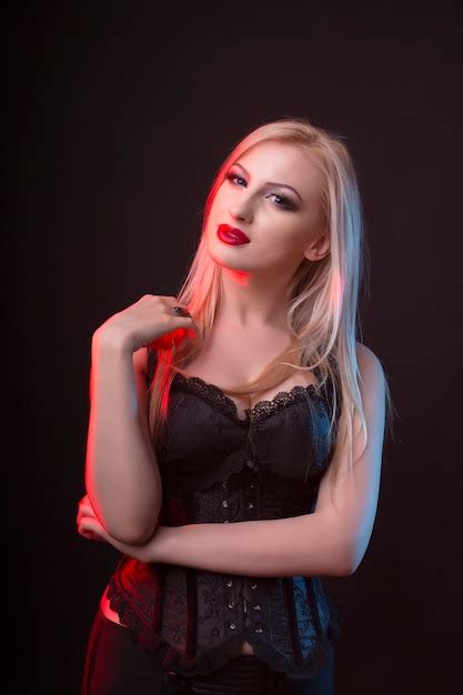 Premium Photo Splendid Blonde Model In A Corset With Red And Blue Light