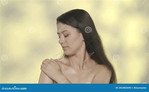 Closeup Studio Shot Of Beautiful Female Model Brunette Girl With Long Hair And Nude Makeup