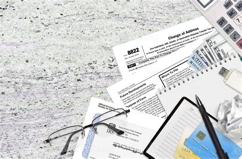 IRS form 8822 Change of Address lies on flat lay office table and ready