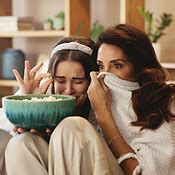 Popcorn Mature Mother And Scared Daughter On Sofa With Bonding Fear And Watching Tv In Living