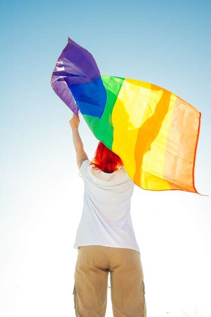 Premium Photo Back View Of Lesbian Waving Colorful Flag Of Lgbt Movement During Pride Parade