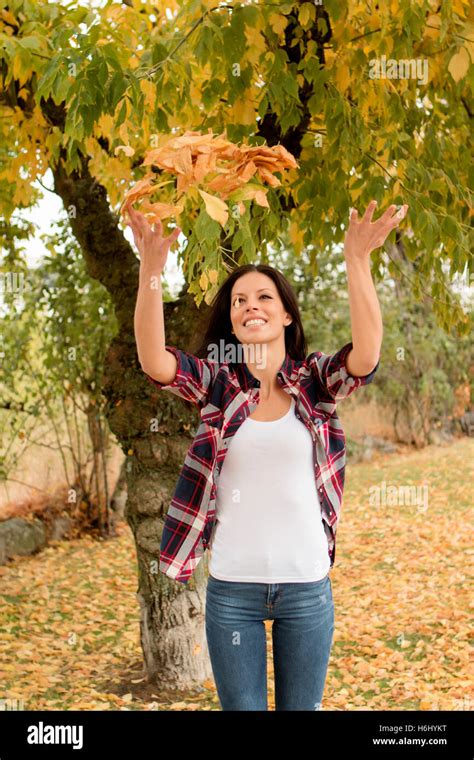 Beautiful Brunette Girl Taking A Walk By A Park In Autumn Stock Photo Alamy