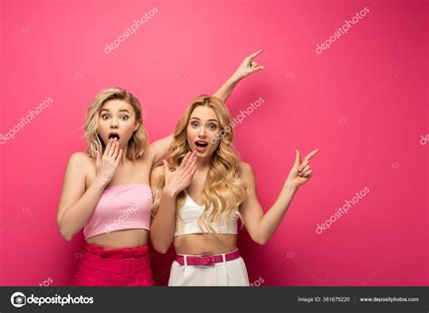 Excited Blonde Women Looking Camera While Pointing Fingers Pink Background Stock Photo By