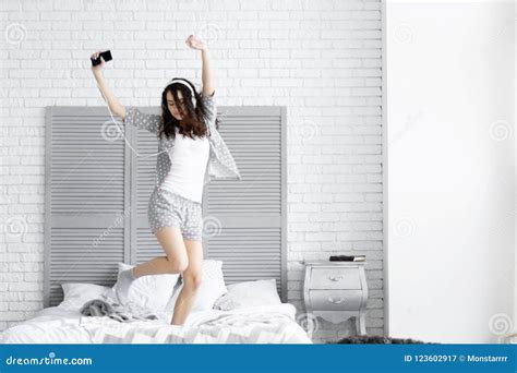 Happy Brunette Woman Wears Grey Pajamas Morning Concept Stock Image Image Of Headphones