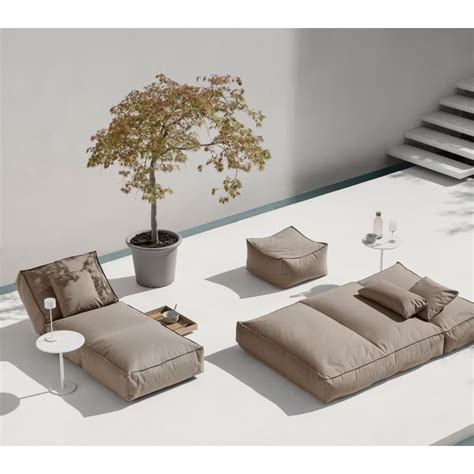 A Living Room With Couches And A Tree In The Middle On Top Of A White