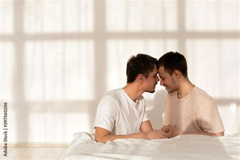 Cute Gay Couple Touch Their Foreheads With Closed Eyes Against The