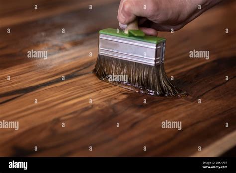 Hand Of A Carpenter Designer Oiling An Authentic Self Made Table With A