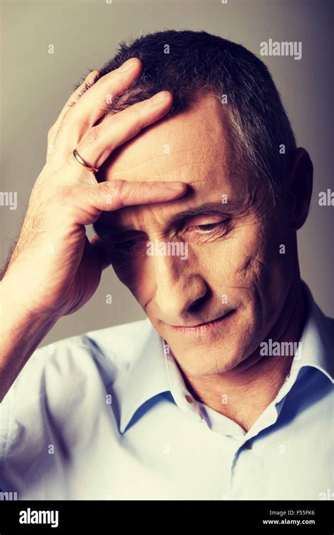 Depressed Mature Man Touching His Head Stock Photo Alamy