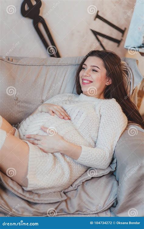 Pregnant Brunette Girl In A White Knitted Sweater Lying In Armchair Stock Photo Image Of Girl