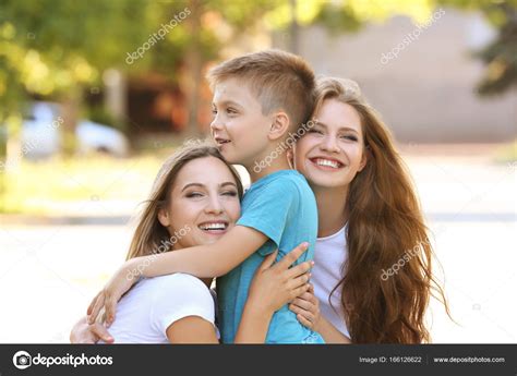 Lesbian Mothers And Foster Son Having Fun Outdoors Stock Photo Belchonock 166126622