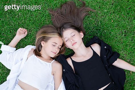 Fraternal Twins Sisters Blonde And Brunette Teen Girls In Fashionable Black And White Clothes