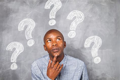 man thinking  hard  standing infront   chalkboard stock