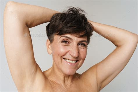 Mature Half Naked Woman Smiling While Showing Her Armpits Stock Photo