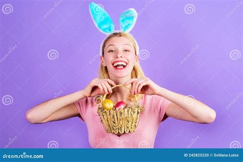 Easter Day Smiling Girl In Rabbit Ears With Basket Of Colored Eggs