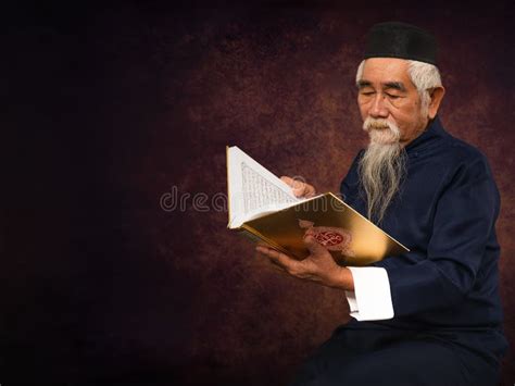 Old Asian Muslim Prayer Sitting And Read Holy Al Quran Book Stock Photo