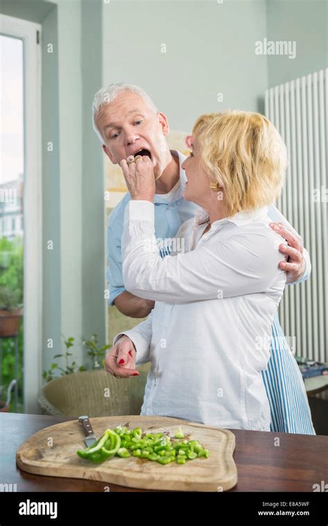 Mature Woman Feeding Food To Mature Man Stock Photo Alamy