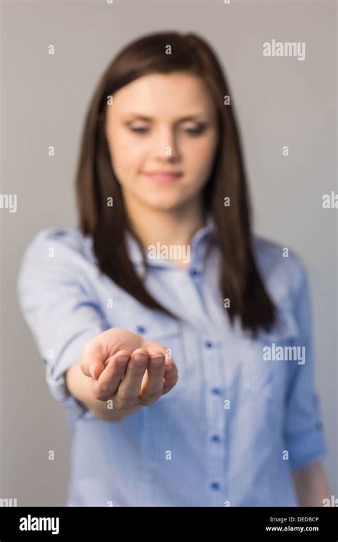Cheerful Pretty Brunette Presenting Her Empty Hand Stock Photo Alamy