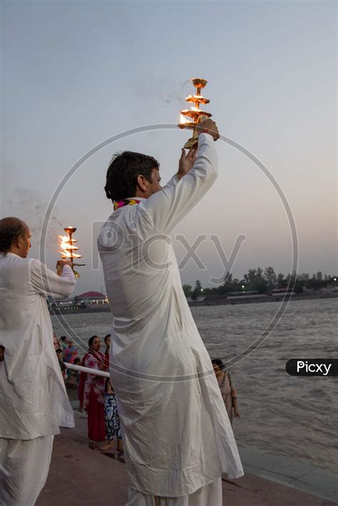 Image Of Priest Performing Haarthi Or Aarthi To Holy River Ganges In