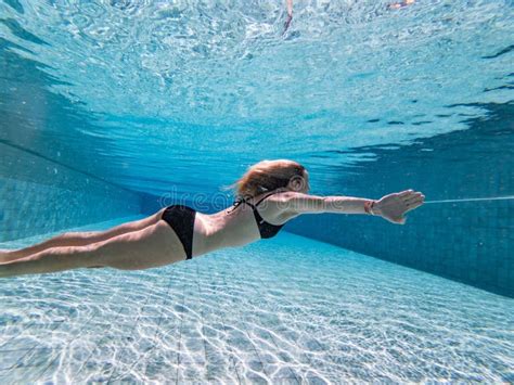 Woman Swimming Underwater In A Pool Wearing A Black Bikini Stock Image Image Of Aquatic