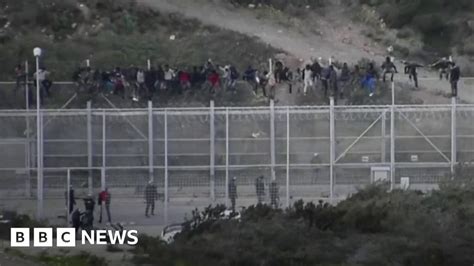 Migrants Storm Border Fence At Spanish Enclave Bbc News