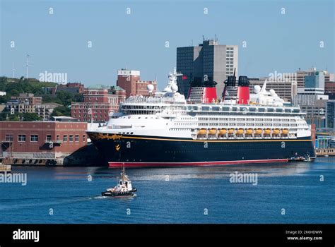 tugboat passing   cruise ship moored  halifax city port nova