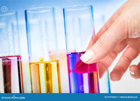 womans hand choosing  laboratory testing tube stock image image