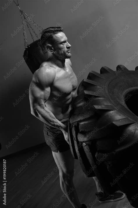 Functional Training Muscular Strong Man With Naked Troso Lifting Heavy Tire Stock Photo