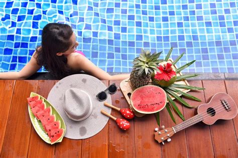 Beautiful Asian Bikini Girl Relaxing In Swimming Pool Stock Photo