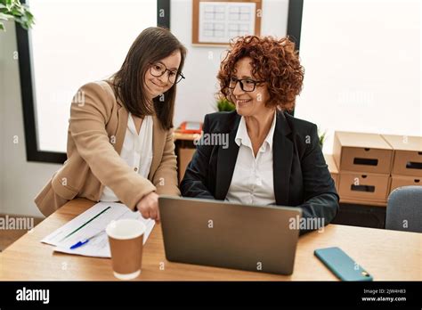 Group Of Two Women Working At The Office Mature Woman And Down