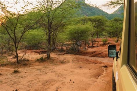 Side View Of A Safari Vehicle Against A Mountain Background At Ngurunit