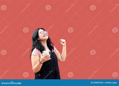 Brunette Latina Teen Woman With Eyeglasses And Brackets Uses Her Cell Phone To Text Shop And