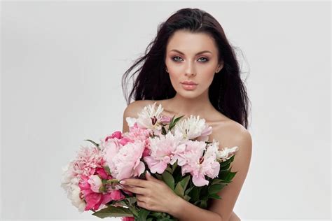 Premium Photo Sexy Brunette Woman Holding A Large Bouquet Of Peony Flowers
