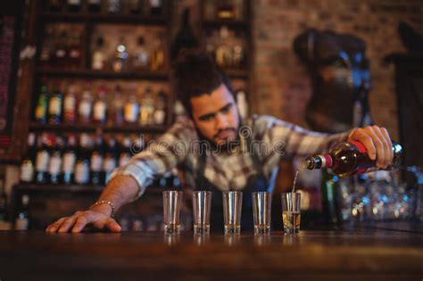 Waiter Pouring Tequila Into Shot Glasses At Counter Stock Image Image Of Male Lifestyle 92206135