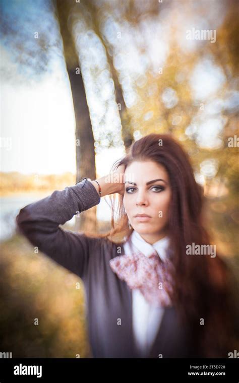 In This Mesmerizing Portrait A Brunette Woman Takes Center Stage Amidst The Enchanting Colors