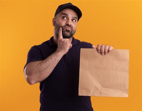 Free Photo Thinking Middle Aged Delivery Man In Uniform And Cap