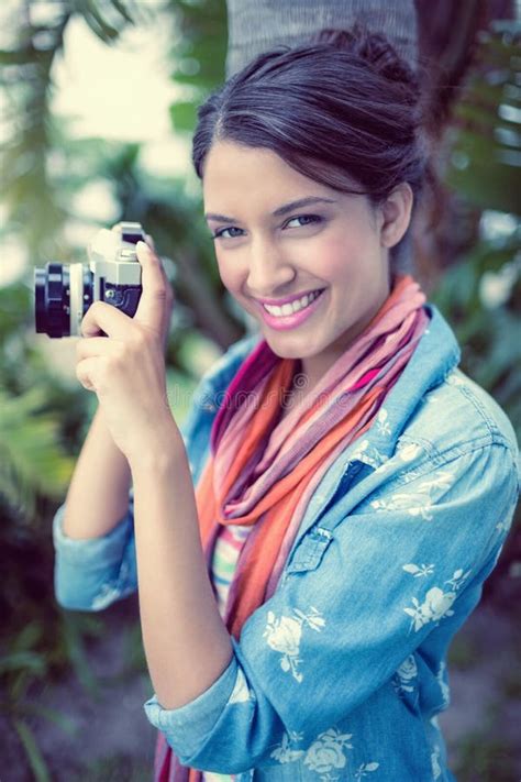 Cheerful Brunette Taking A Photo Outside Smiling At Camera Stock Photo Image Of Fashionable