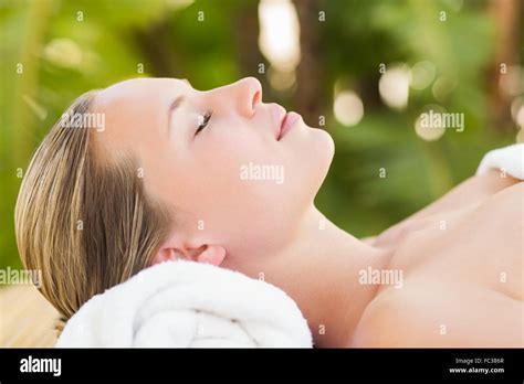 Peaceful Blonde Lying On Towel Smiling At Camera Stock Photo Alamy