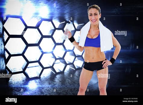 Composite Image Of Strong Blonde Holding Water Bottle Smiling At Camera